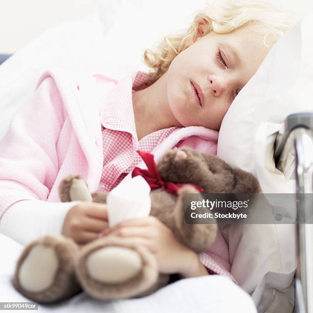 close-up of a girl (8-10) sleeping in a wheelchair holding her teddy bear - cast of amcs low winter sun q a with art house convergence stockfoto's en -beelden