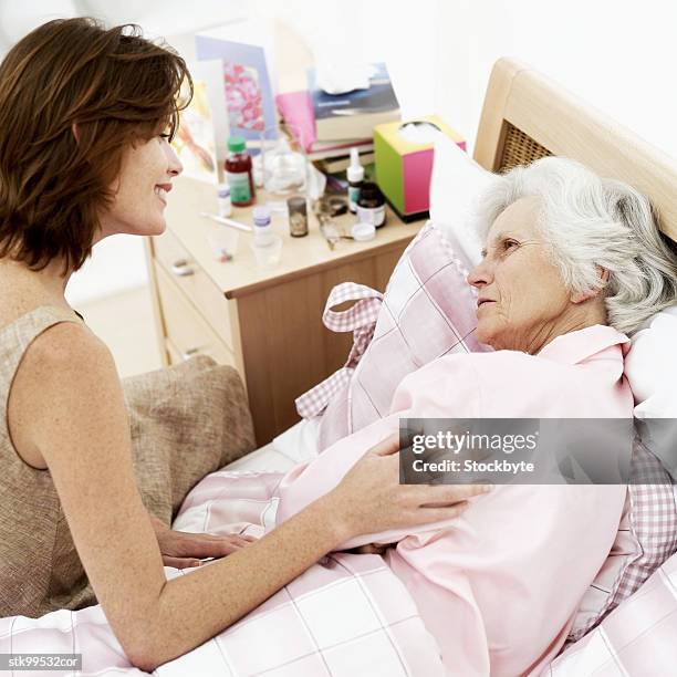 granddaughter talking to her ill grandmother - her fotografías e imágenes de stock