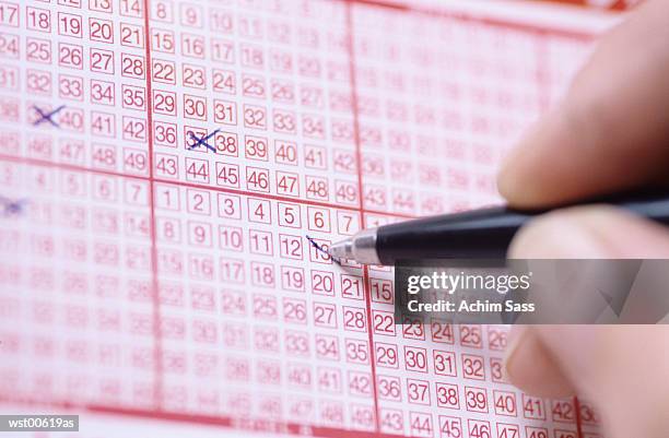 pen markings on lottery ticket - kansspel stockfoto's en -beelden