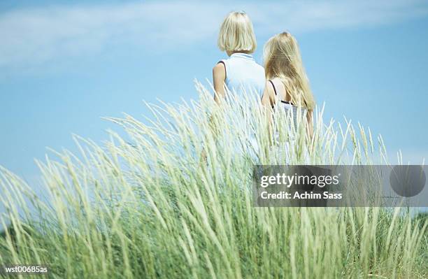 two girls standing, rear view - middle childhood stock pictures, royalty-free photos & images