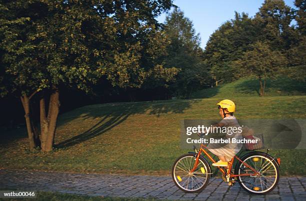 girl riding her bicycle - her bildbanksfoton och bilder