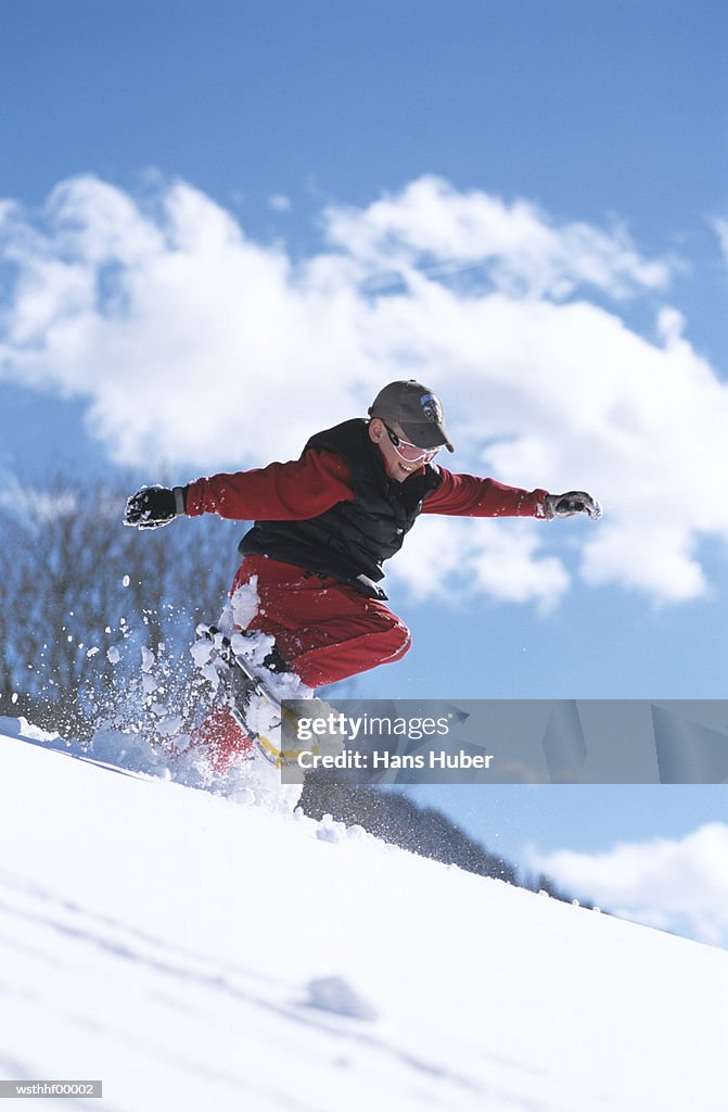 Boy snowboarding mid air