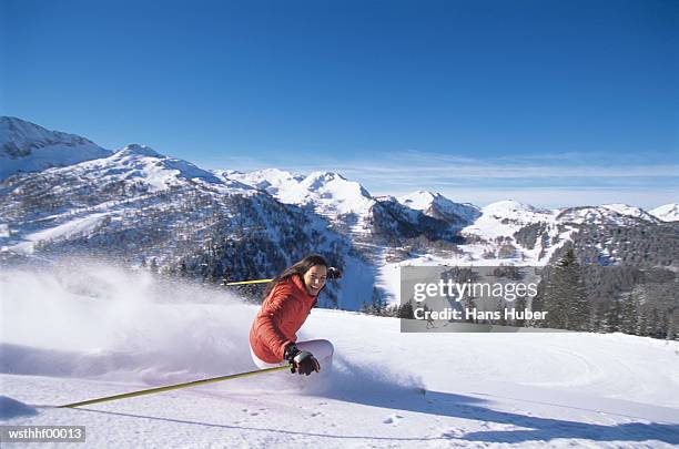 woman skiing on slope - wasserform stock-fotos und bilder
