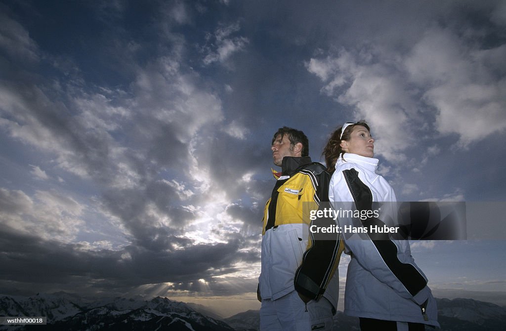 Couple standing back to back