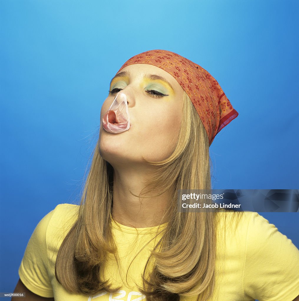 Teenage girl eating bubble gum