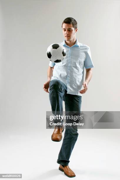 man keeping football in the air with his knee - the who stock pictures, royalty-free photos & images