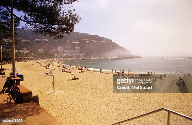 people at beach of ilafranc, costa brava, catalonia, spain - costa stock-fotos und bilder