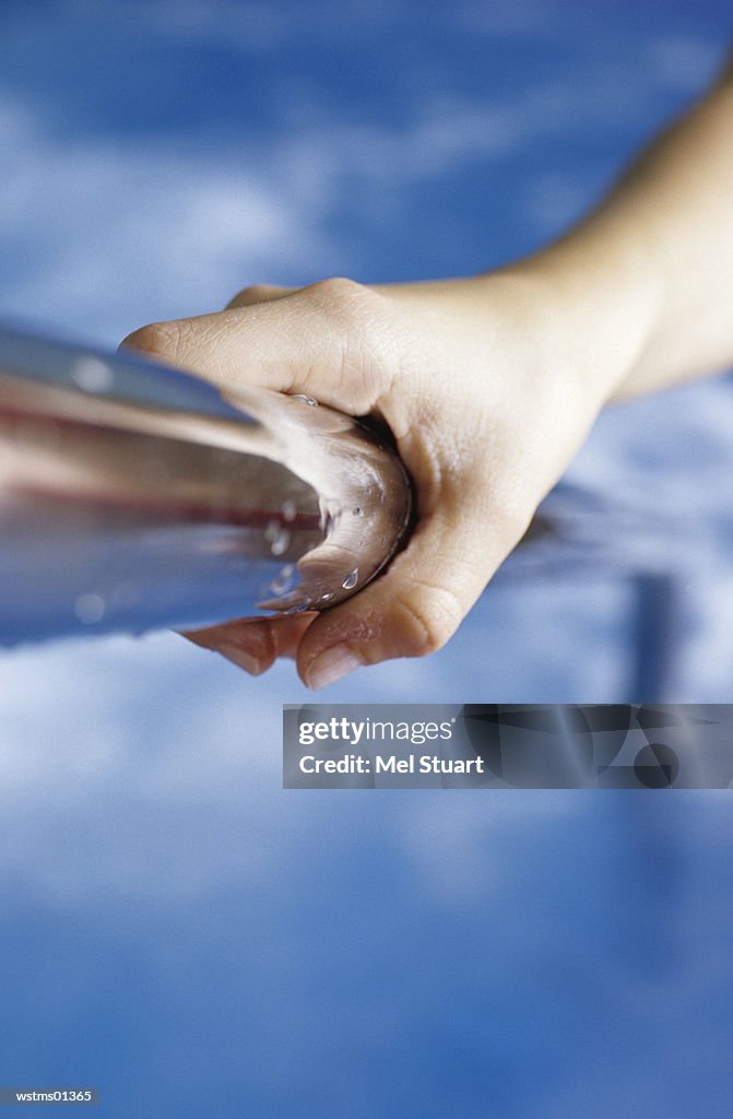 Human hand holding steel bar