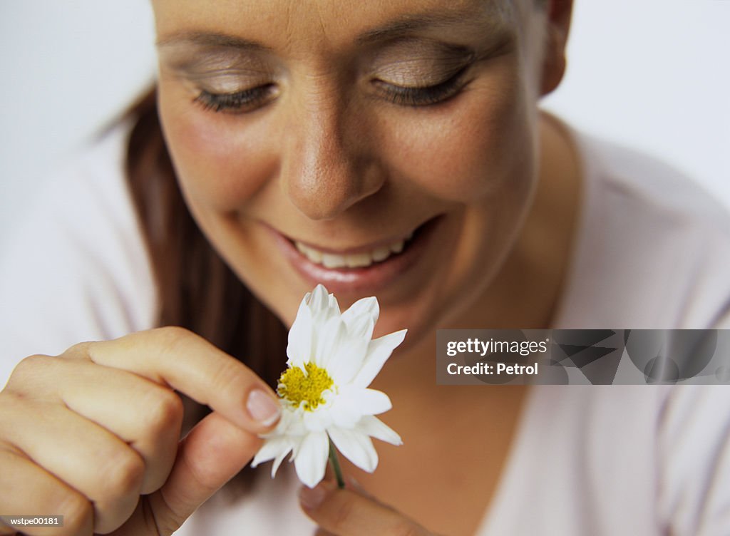 Woman plucking petals of flower