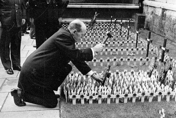 A rectangle of miniature crosses being planted outside Westminster Abbey London on Remembrance Day to commemorate those who died in the two world wars