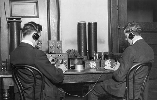 Early radio ham operators trying to make contact with other members of the fraternity.