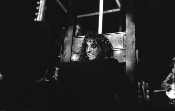Alice Cooper with his head in a guillotine