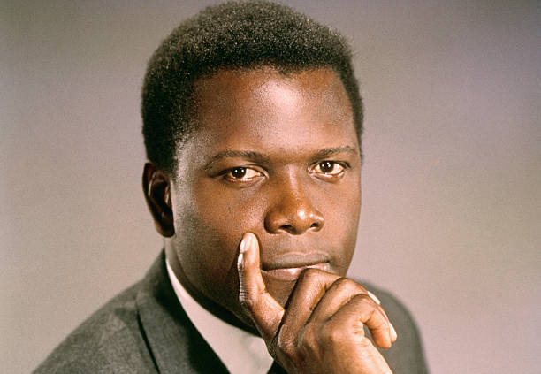 Hollywood, CA-ORIGINAL CAPTION READS: Close-up photo of American actor Sidney Poitier, looking straight ahead with his hand wrapped around his chin.