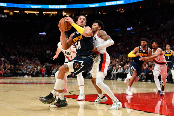 Aaron Gordon of the Denver Nuggets in action against Anfernee Simons of the Portland Trail Blazers during the fourth quarter at Moda Center on...