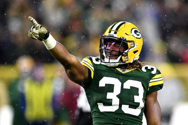 Aaron Jones of the Green Bay Packers celebrates a first down against the Carolina Panthers during the third quarter in the game at Lambeau Field on...