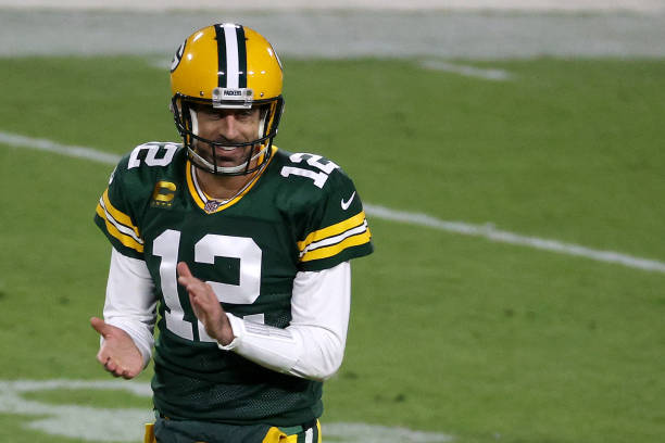 Aaron Rodgers of the Green Bay Packers celebrates following a touchdown completion to Robert Tonyan the second quarter of their game against the...