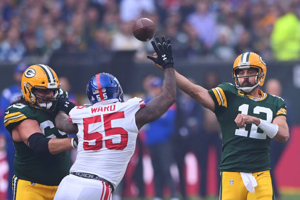 Aaron Rodgers of the Green Bay Packers throws a pass in the first half during the NFL match between New York Giants and Green Bay Packers at...