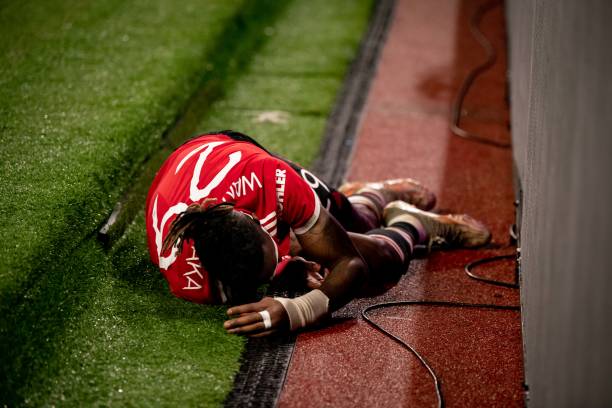 Aaron Wan-Bissaka of Manchester United lies injured during the UEFA Champions League group F match between Manchester United and BSC Young Boys at...