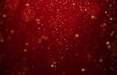 Abstract, defocused red and gold glittering background