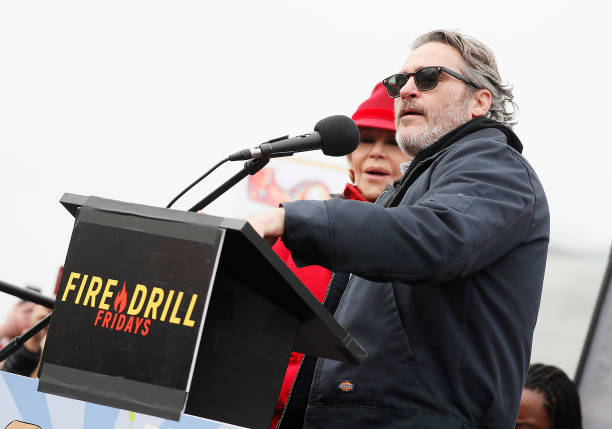 Actor Joaquin Phoenix onstage with actress and activist Jane Fond during the last Fire Drill Fridays climate change protest and rally on Capitol Hill...