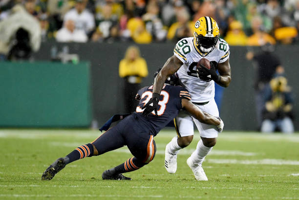 Adrian Amos of the Chicago Bears tackles Martellus Bennett of the Green Bay Packers in the third quarter at Lambeau Field on September 28, 2017 in...