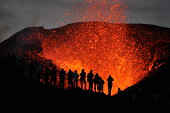 Adventurers witnessing a Volcanic Eruption