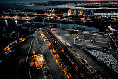 Aerial view of the New Jersey Shipyard with numerous cranes, gantries and shipping containers, captured at golden hour