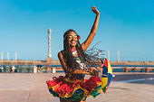 Afro dancer holding a Frevo umbrella in Marco Zero