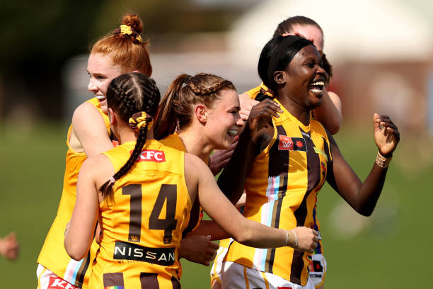 Akec Makur Chuot of the Hawks celebrates kicking a goal with team mates during the round eight AFLW match between the Greater Western Sydney Giants...