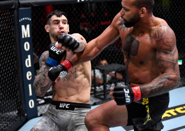 Aleksandar Rakic of Austria punches Thiago Santos of Brazil in their light heavyweight fight during the UFC 259 event at UFC APEX on March 06, 2021...