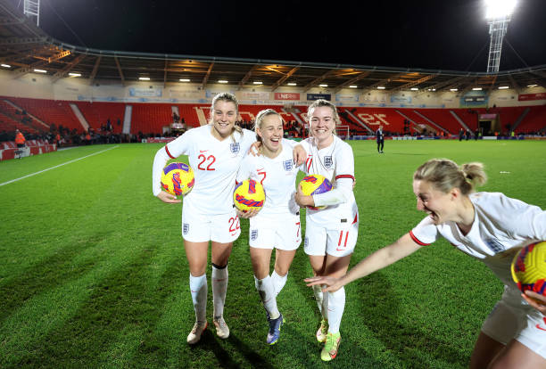 Alessia Russo, Beth Mead, Lauren Hemp and Ellen White of England attempt to pose for a photograph with their match balls after each of them scored a...