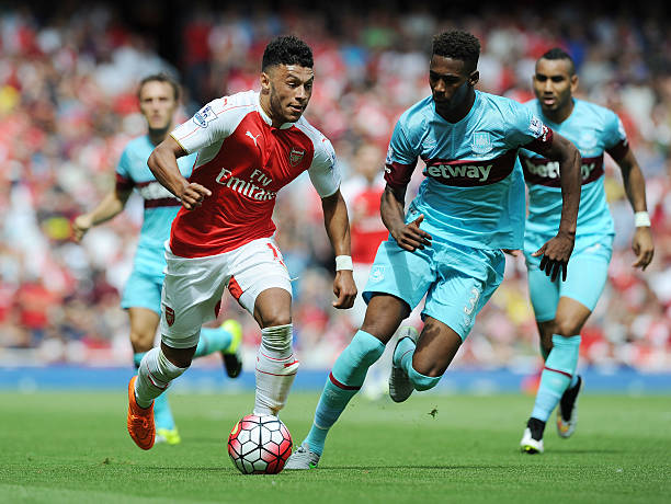 Alex Oxlade-Chambrlain of Arsenal breaks past Reece Oxford of West Ham during the Barclays Premier League match between Arsenal and West Ham United...