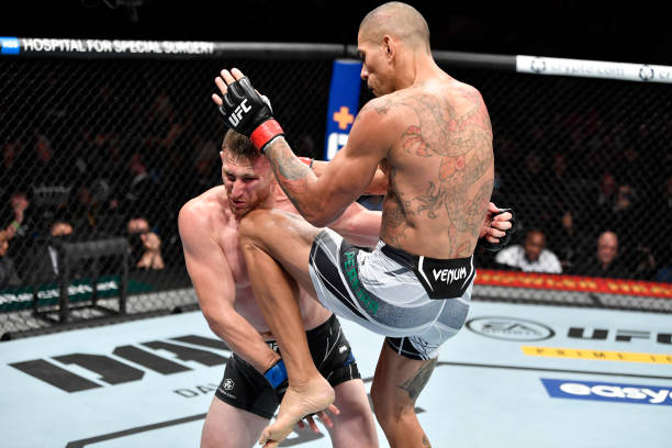 Alex Pereira of Brazil knocks down Andreas Michailidis of Greece with a knee in their middleweight fight during the UFC 268 event at Madison Square...