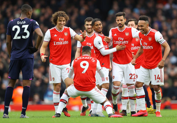 Alexandre Lacazette of Arsenal celebrates with teammates after scoring his team's first goal which was awarded after a VAR review during the Premier...