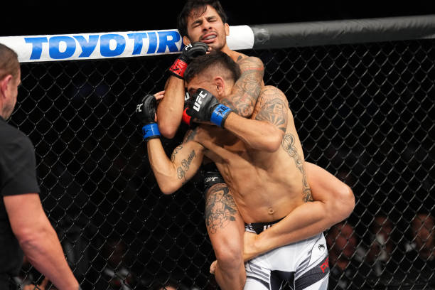 Alexandre Pantoja of Brazil attempts to submit Alex Perez in a flyweight fight during the UFC 277 event at American Airlines Center on July 30, 2022...