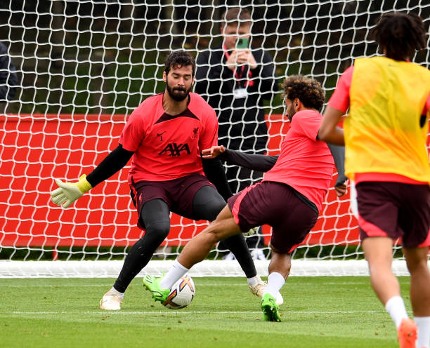 Alisson Becker and Mohamed Salah of Liverpool during a training session at AXA Training Centre on August 04, 2022 in Kirkby, England.