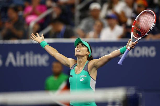 Alize Cornet of France celebrates after defeating Emma Raducanu of Great Britain in their Women's Singles First Round match on Day Two of the 2022 US...