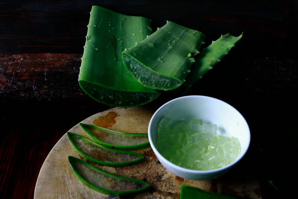 aloe vera on wooden background - aloe vera gel stock pictures, royalty-free photos & images