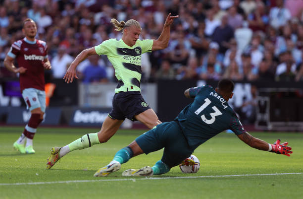 Alphonse Areola of West Ham United brings down Erling Haaland of Manchester City to concede a penalty during the Premier League match between West...