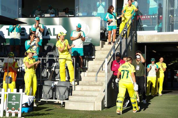 Alyssa Healy of Australia gets a standing ovation from her team mates as shel eaves the field during the 2022 ICC Women's Cricket World Cup Final...