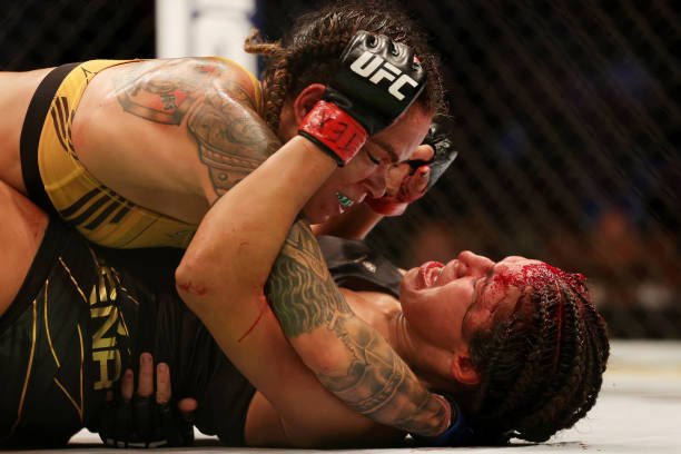 Amanda Nunes of Brazil grapples with Julianna Pena in their bantamweight title bout during UFC 277 at American Airlines Center on July 30, 2022 in...