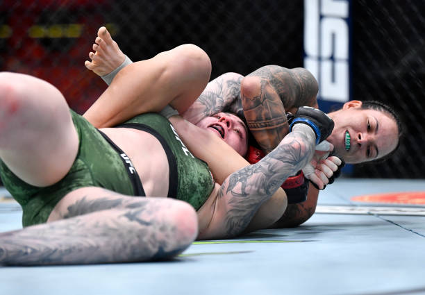 Amanda Nunes of Brazil secures an arm bar submission against Megan Anderson of Australia in their UFC featherweight championship fight during the UFC...