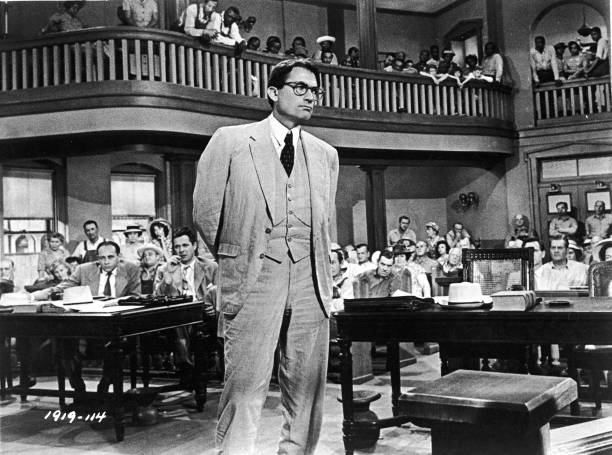 American actor Gregory Peck, as Atticus Finch, stands in a courtroom in a scene from director Robert Mulligan's film, 'To Kill A Mockingbird,' 1962....