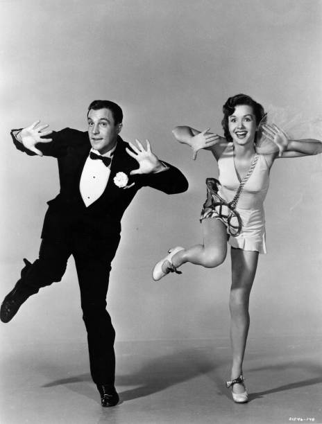 American actor-dancer Gene Kelly rehearsing with Debbie Reynolds for the MGM musical `Singin` In The Rain`, directed by Gene Kelly and Stanley Donen.