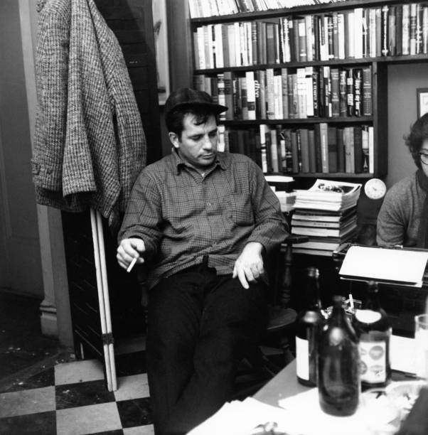 American author and poet Jack Kerouac contemplates a poem at the apartment of photographer McDarrah and his soon-to-be wife, Gloria, New York, New...