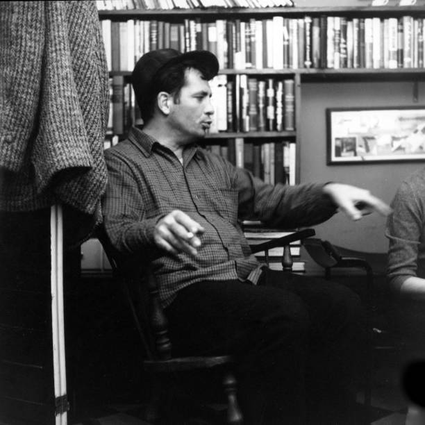 American author and poet Jack Kerouac contemplates a poem at the apartment of photographer McDarrah and his soon-to-be wife, Gloria , New York, New...
