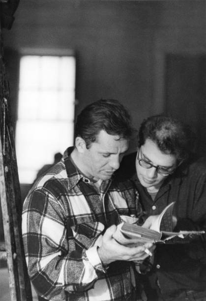 American beat writers Jack Kerouac and Allen Ginsberg read a book together, 1959. Kerouac holds a cigarette in one hand.