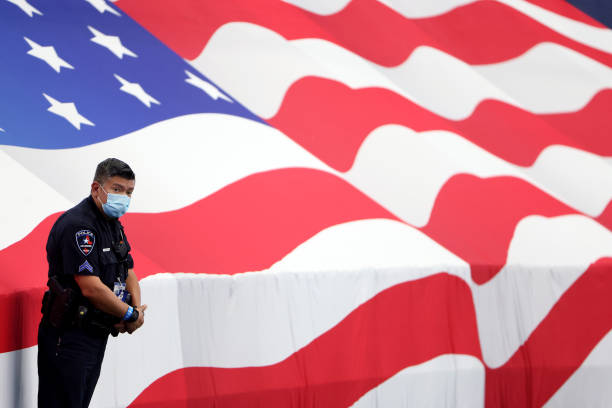 An Arlington Police officer stands on the sidelines as the Dallas Cowboys take on the Atlanta Falcons at AT&T Stadium on September 20, 2020 in...