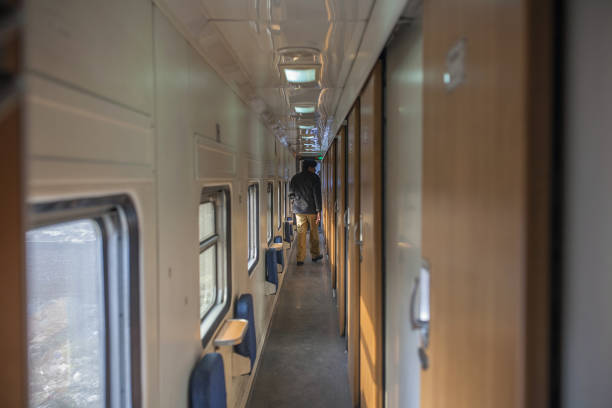 An armed police officer patrols a coach corridor of a Green Line Express train an express service operated by Pakistan Railways between Islamabad and.