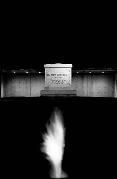 An eternal flame glows in the night in front of Martin Luther King Jr.'s grave.